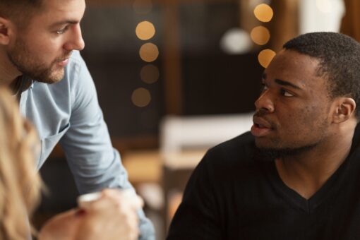 high-angle-male-friends-talking-min